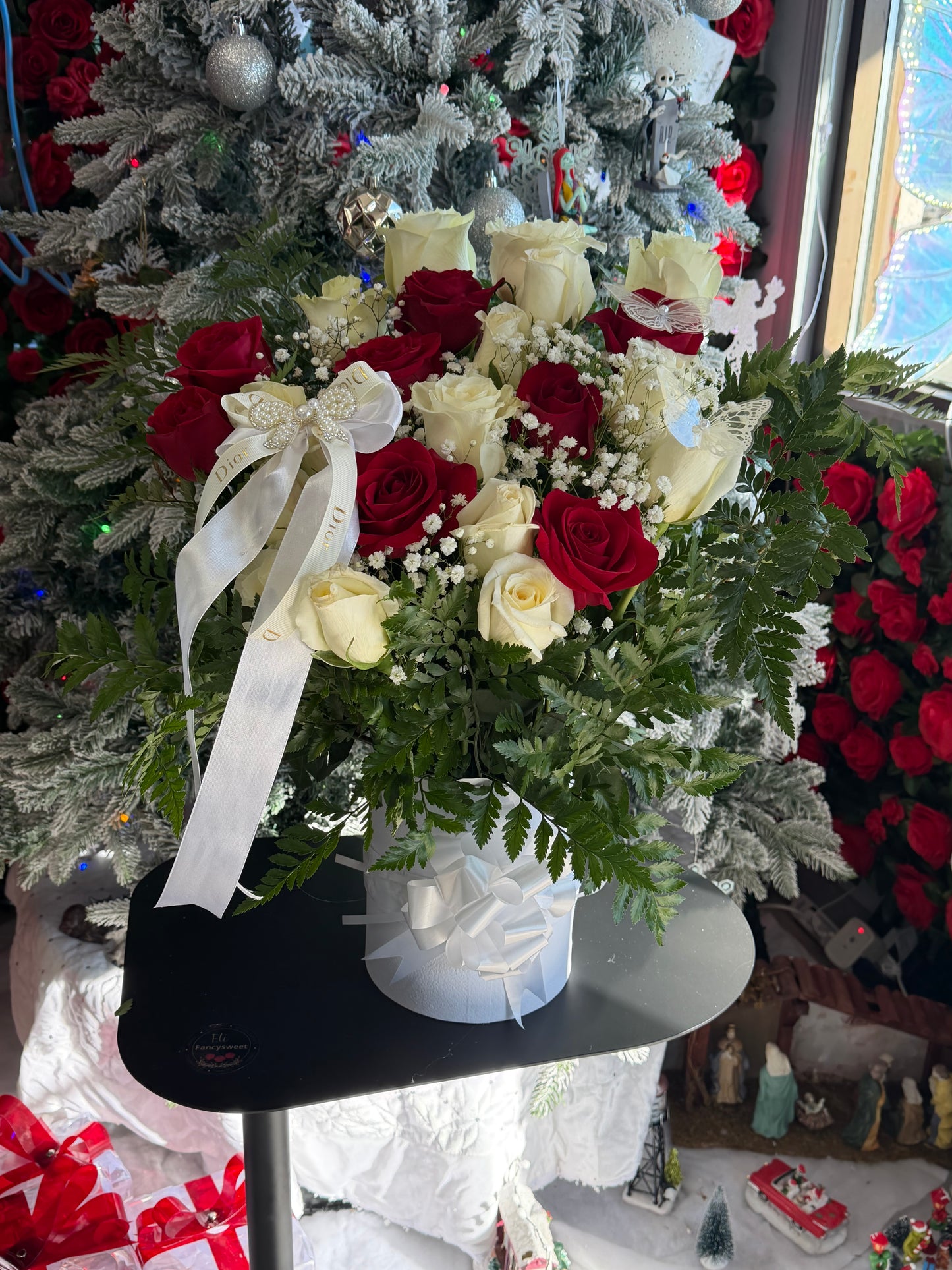 Arreglo floral en base de caja blanca para funeraria 24 rosas ,rojas y blancas con hojas verdes todo alrededor