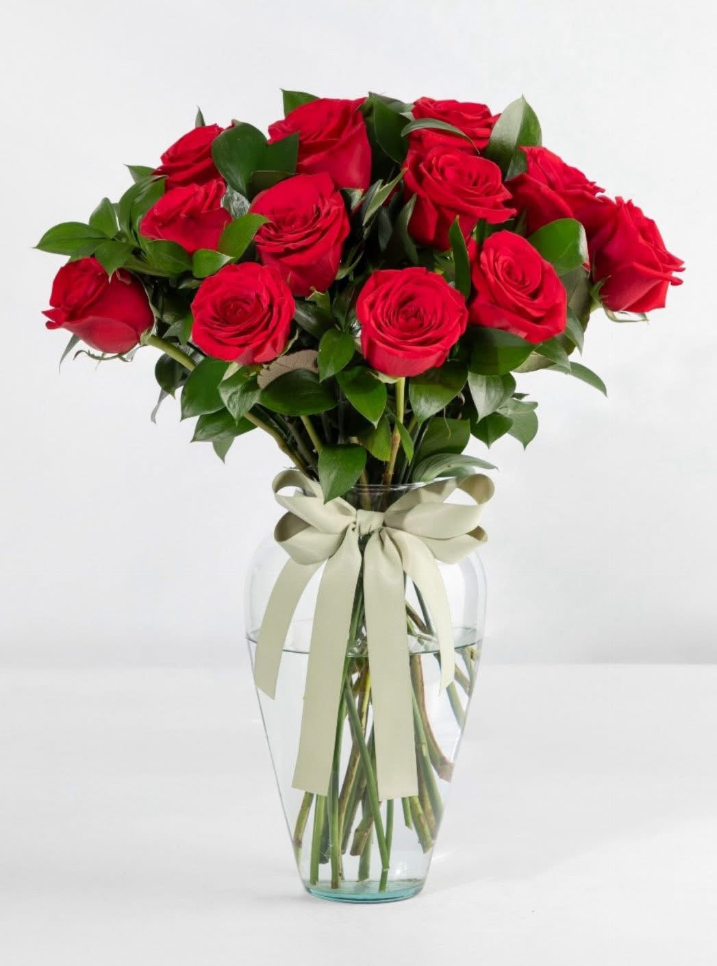 24 rosas rojas  con israelí rúscus en florero